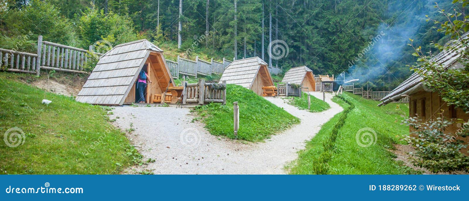 row of small wooden cabins at hija glamping lake bloke in nova vas, slovenia