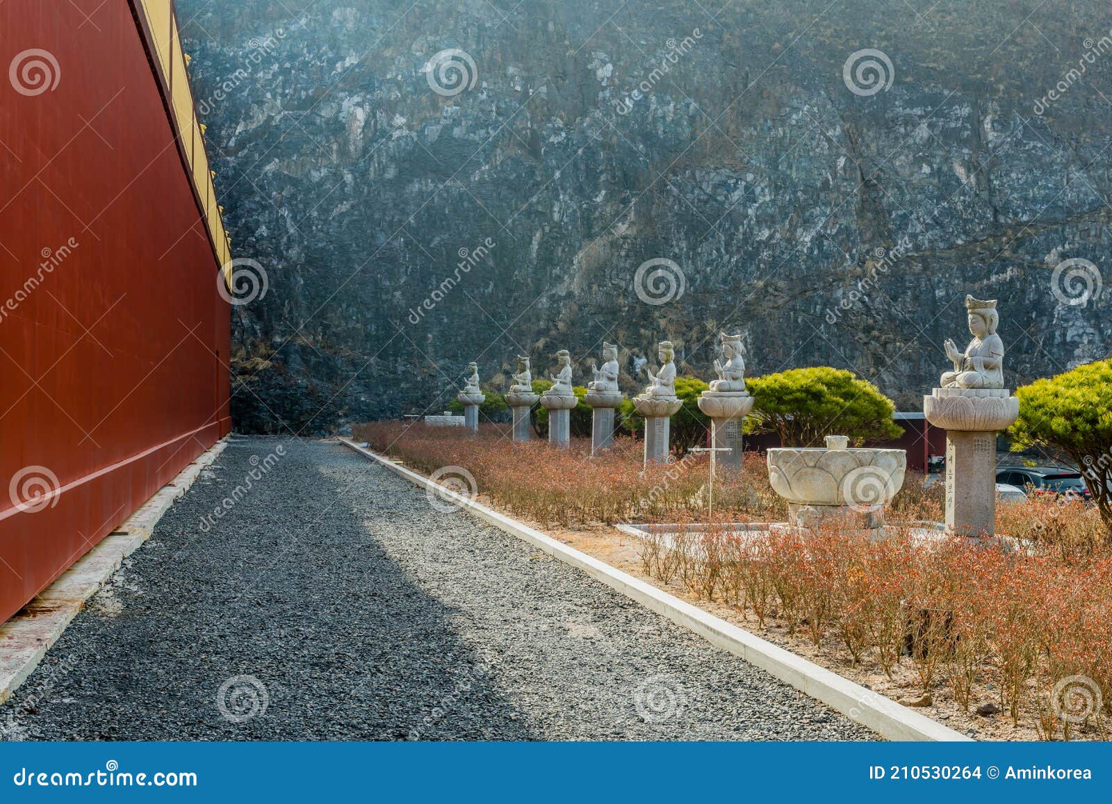 row of stone carved seated buddhas at temple