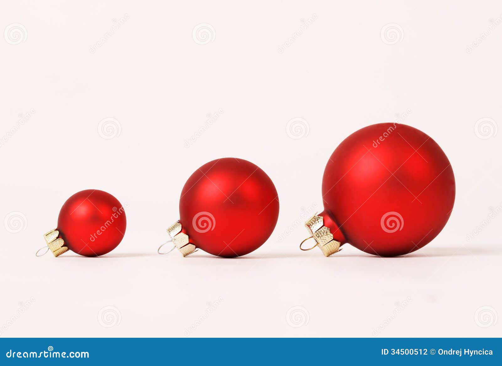 row of three red matt different sizes christmas balls