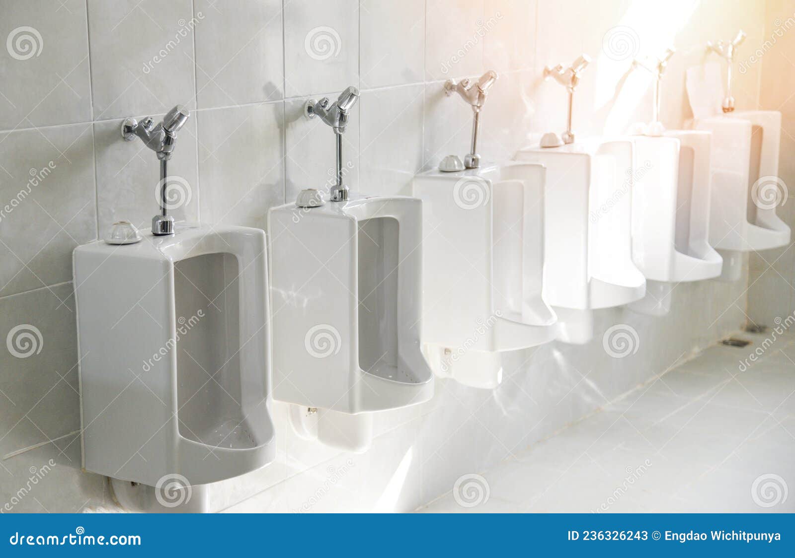 Row of Urinal Toilet Blocks for Man on Tiled Wall in Public Toilet
