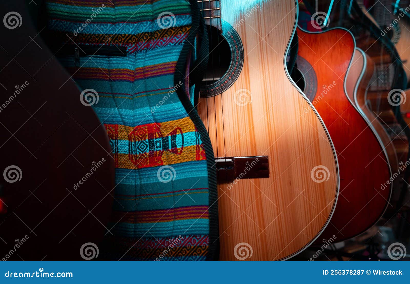 Row of Various Multicolored Acoustic Guitars in a Store Stock Image