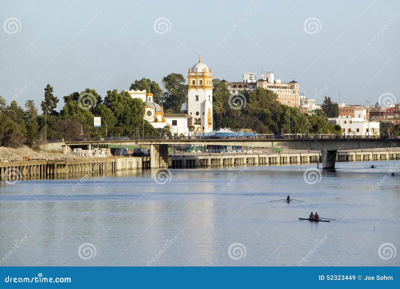 rowers on canal de alfonso of rio guadalquivir river, sevilla, southern spain