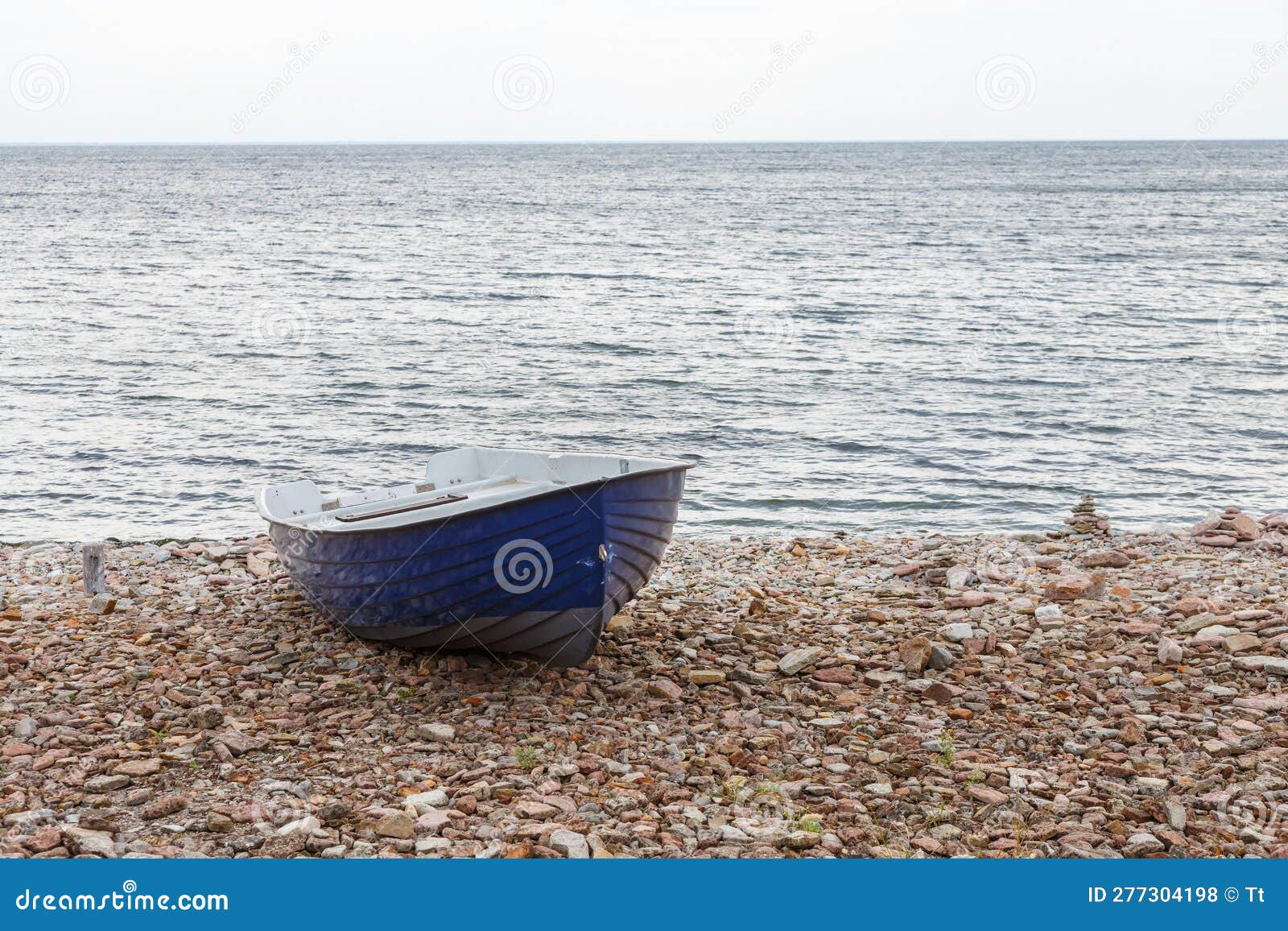 Rowing Boat at a Pebble Beach by the Sea Editorial Stock Photo Image