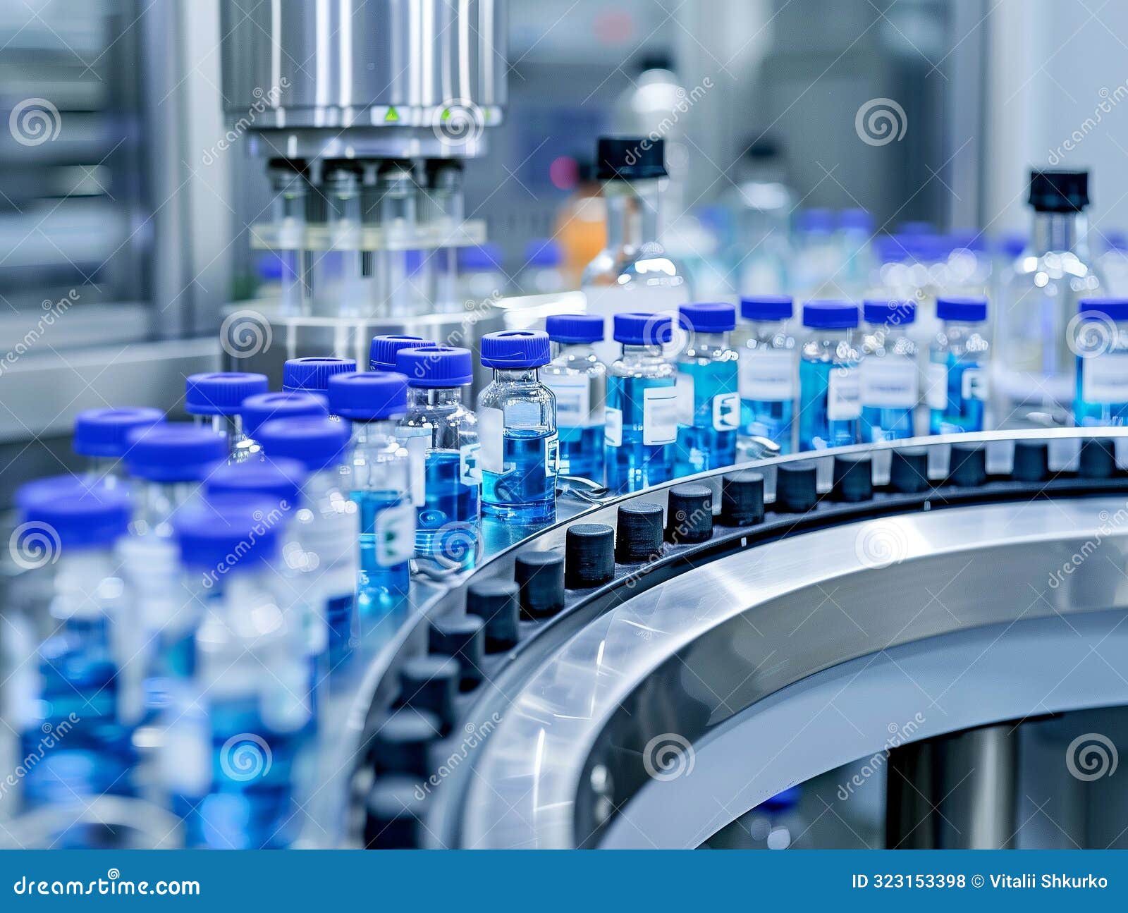 rows of blue-capped pharmaceutical vials filled with liquid on an automated production line in a modern laboratory