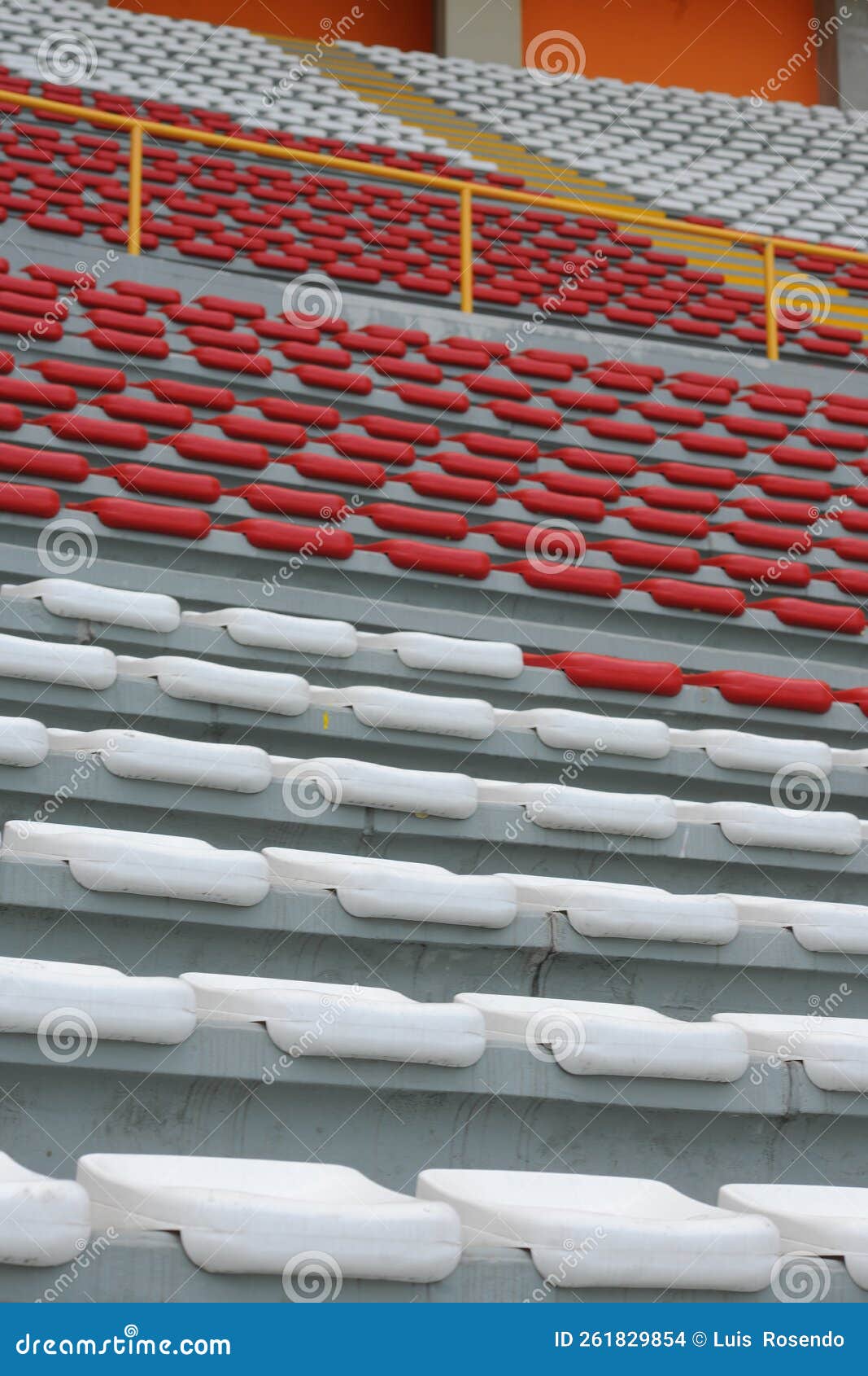 rows of empty orange and white seats in the sports complex of the estadio nacional - soccer stadium - in lima peru