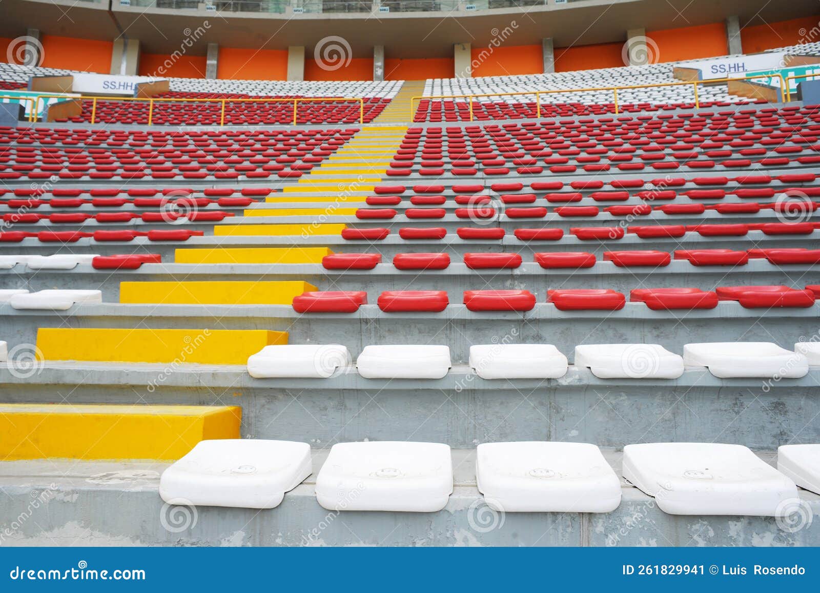 rows of empty orange and white seats in the sports complex of the estadio nacional - soccer stadium - in lima peru