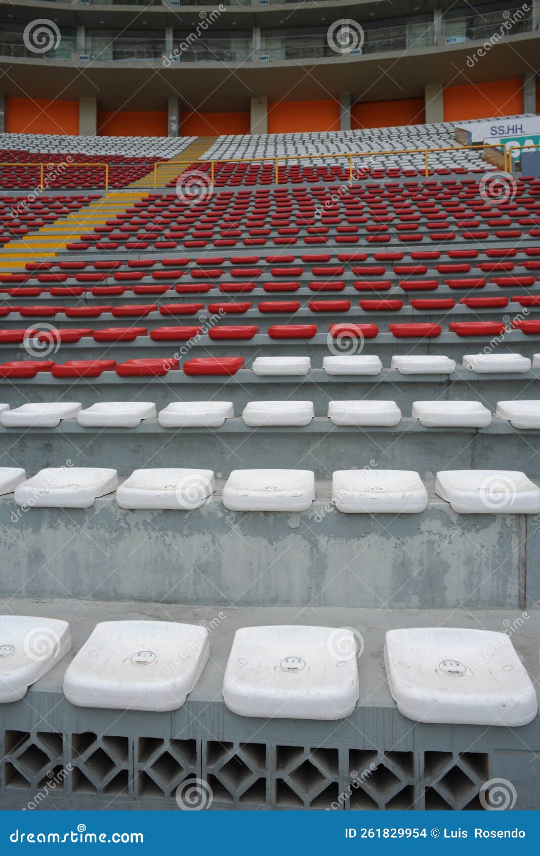 rows of empty orange and white seats in the sports complex of the estadio nacional - soccer stadium - in lima peru