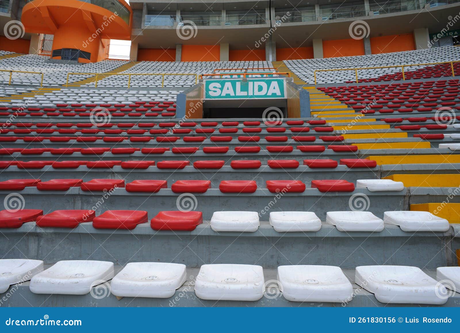 rows of empty orange and white seats in the sports complex of the estadio nacional - soccer stadium - in lima peru