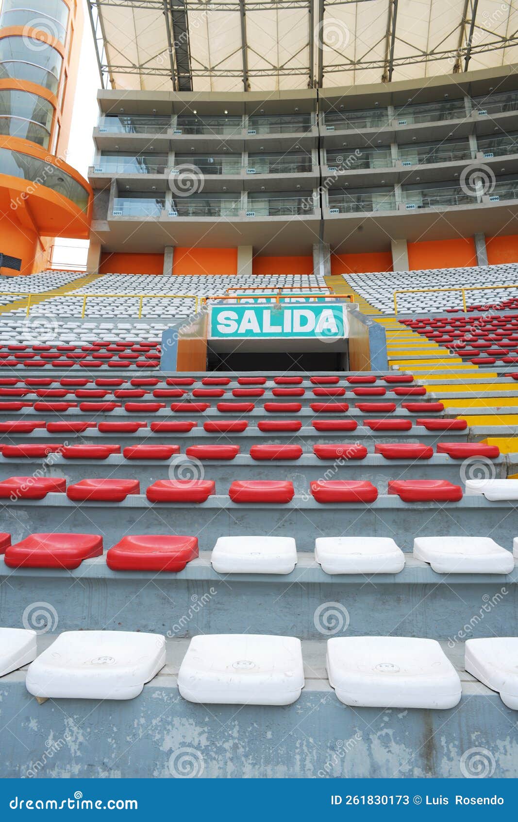 rows of empty orange and white seats in the sports complex of the estadio nacional - soccer stadium - in lima peru