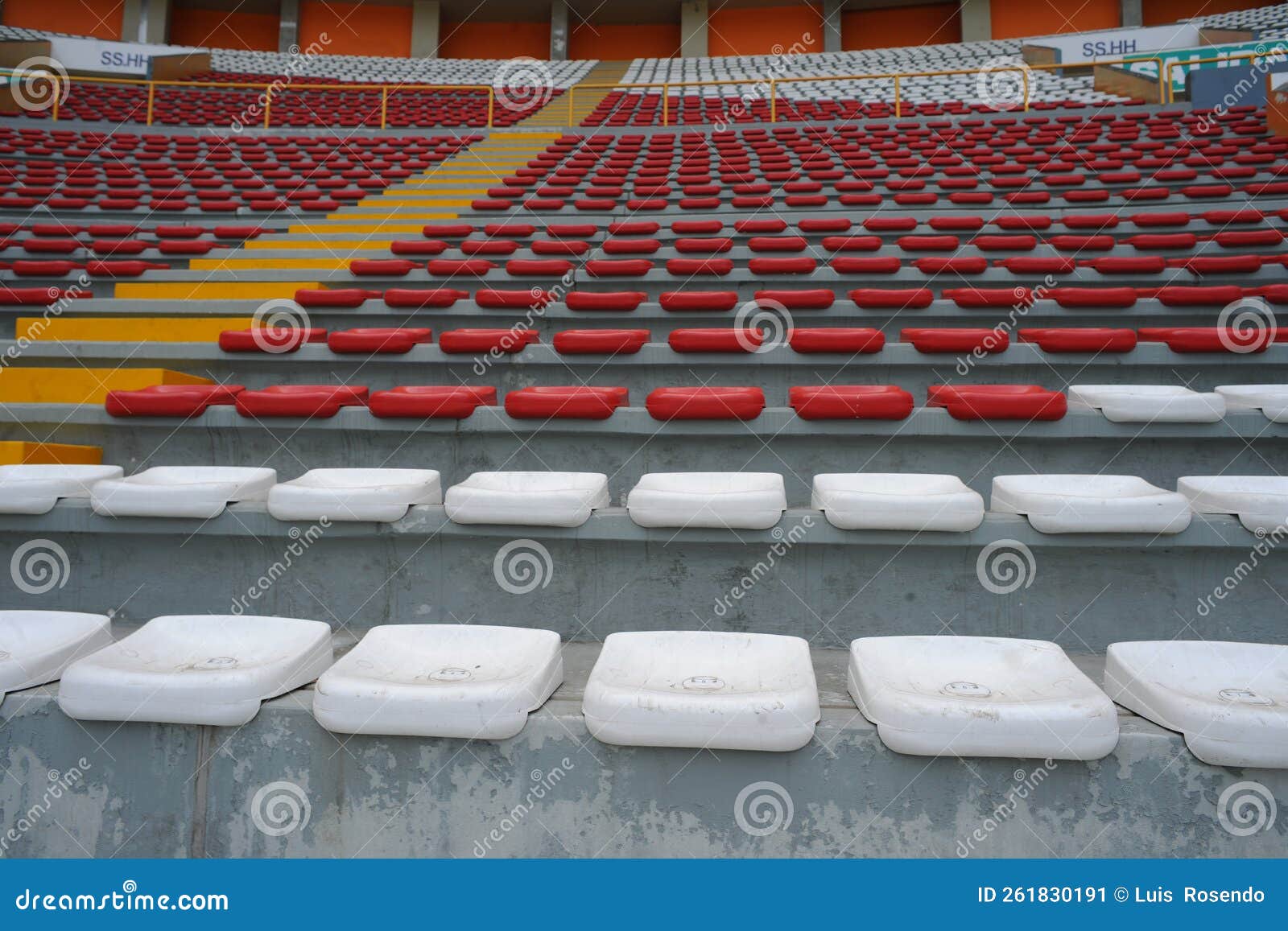 rows of empty orange and white seats in the sports complex of the estadio nacional - soccer stadium - in lima peru