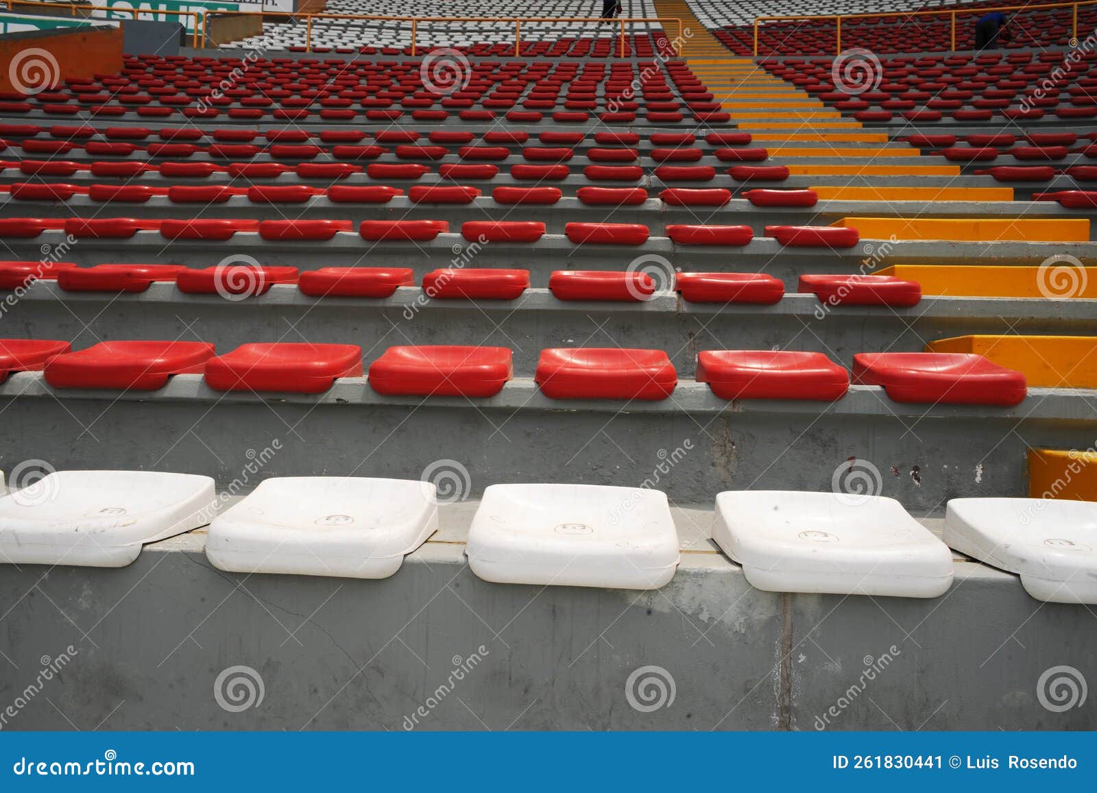 rows of empty orange and white seats in the sports complex of the estadio nacional - soccer stadium - in lima peru