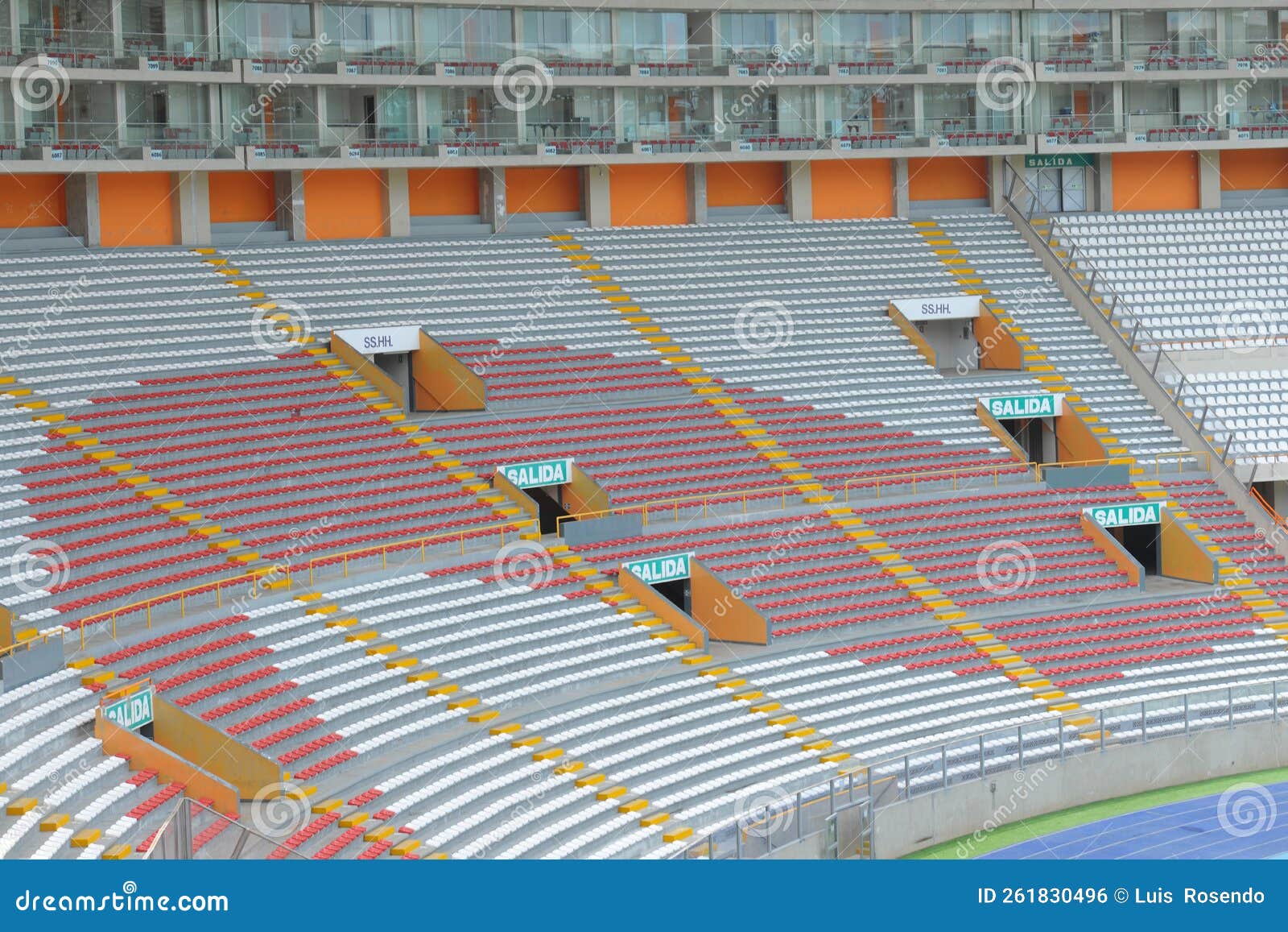 rows of empty orange and white seats in the sports complex of the estadio nacional - soccer stadium - in lima peru