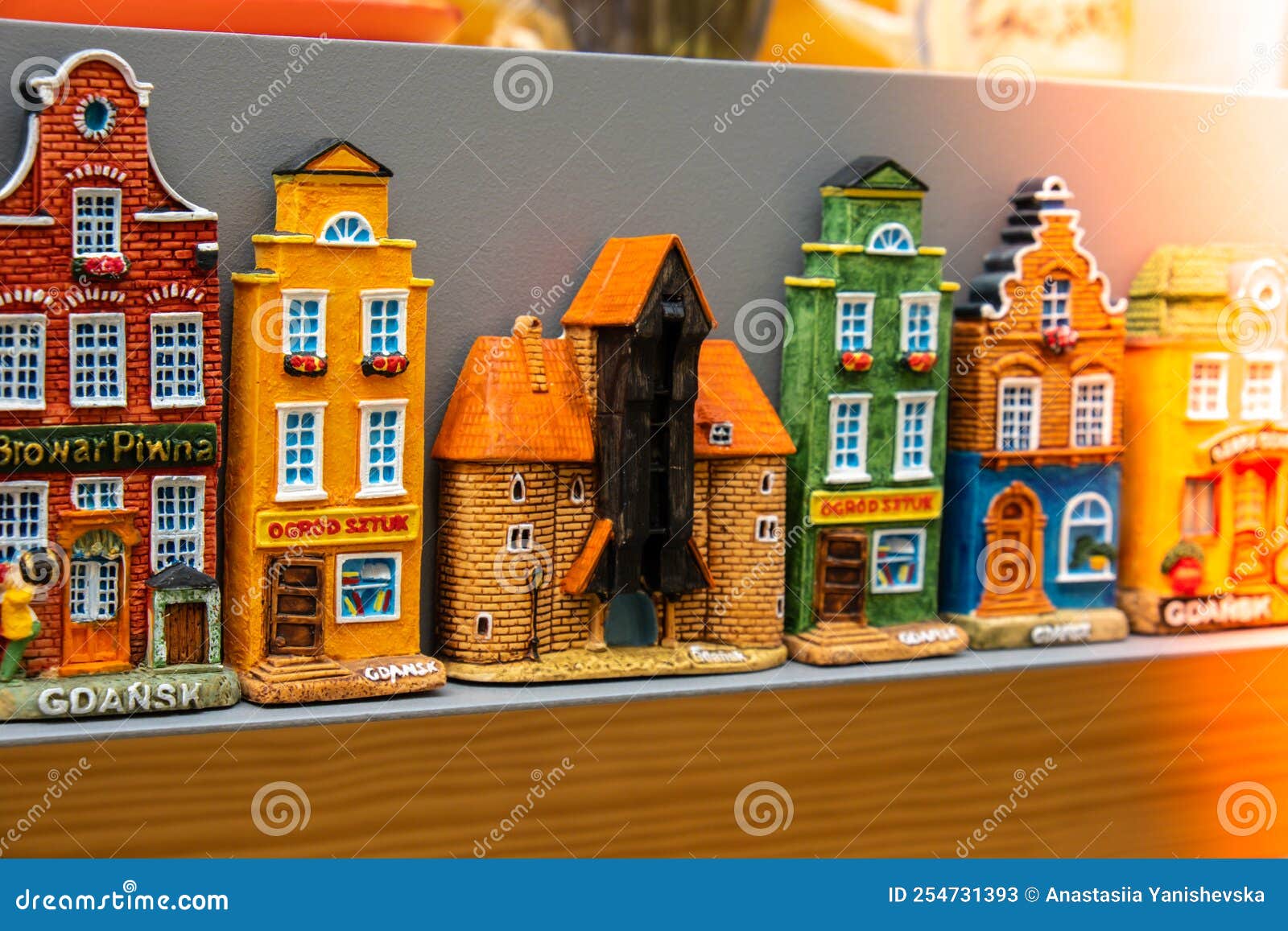 rows of fridge magnet souvenirs from gdansk displayed on stillage. model houses magnets on display in gdansk poland