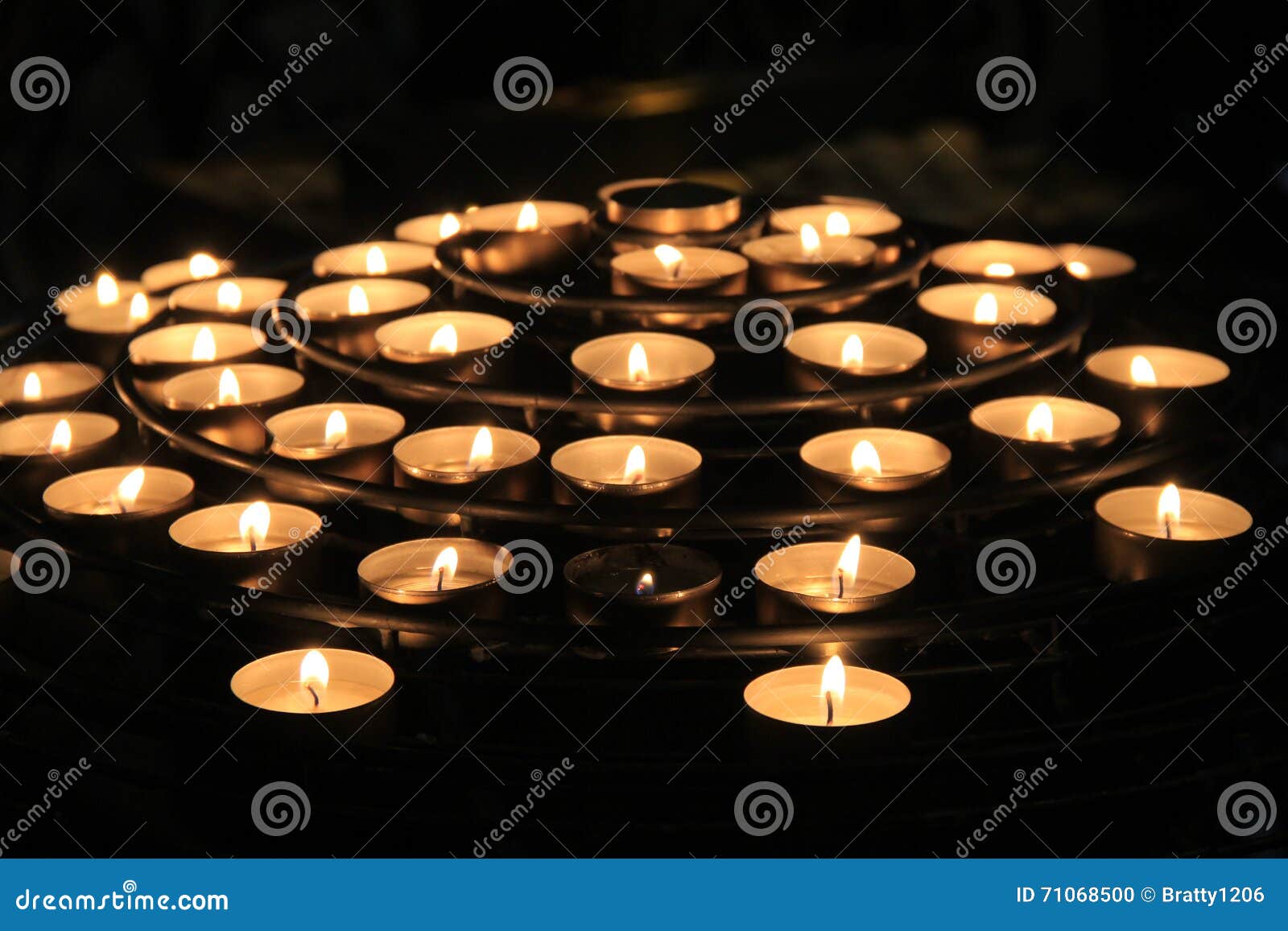 Rows of Lit Candles, Casting Soft Shadows in Room of Prayer Stock Photo