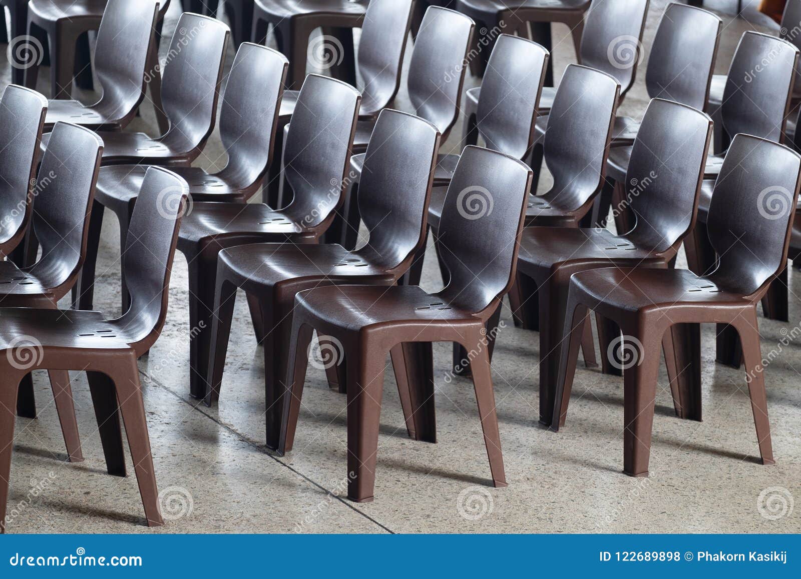 Rows of Modern Brown Plastic Chairs in an Outdoor Event Stock Photo