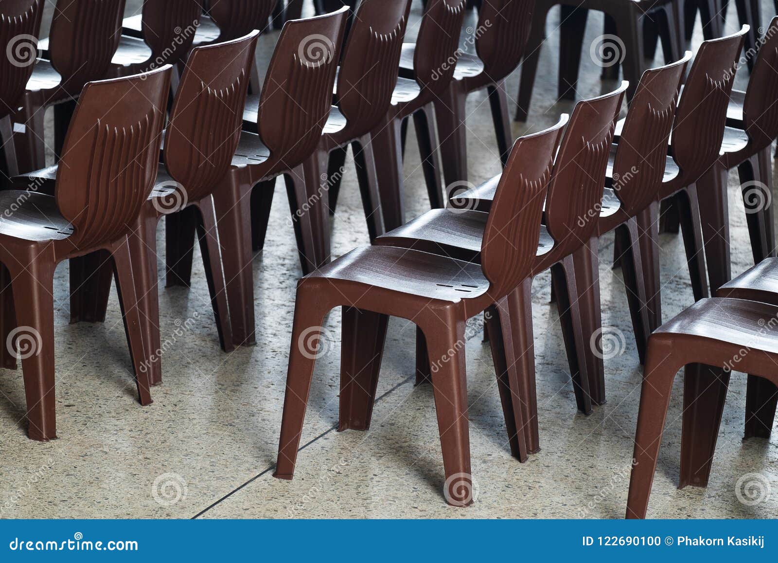 Rows of Modern Brown Plastic Chairs in an Outdoor Event Stock Photo