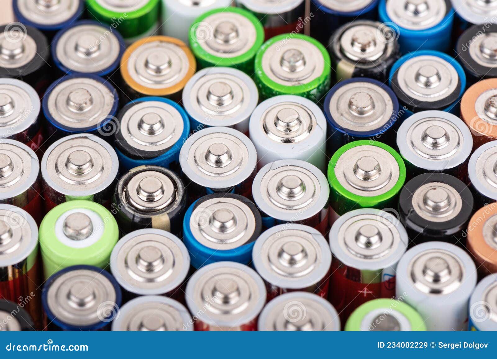Rows of Used Aaa Batteries with the Positive Contact Facing Up. Stock
