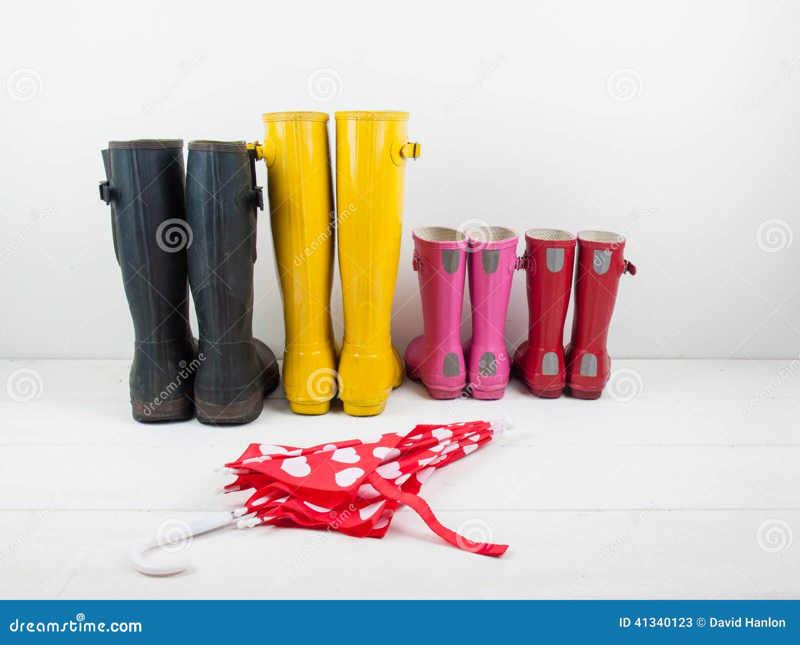 Rubber Boots with an Umbrella Against a White Wall Stock Image - Image ...