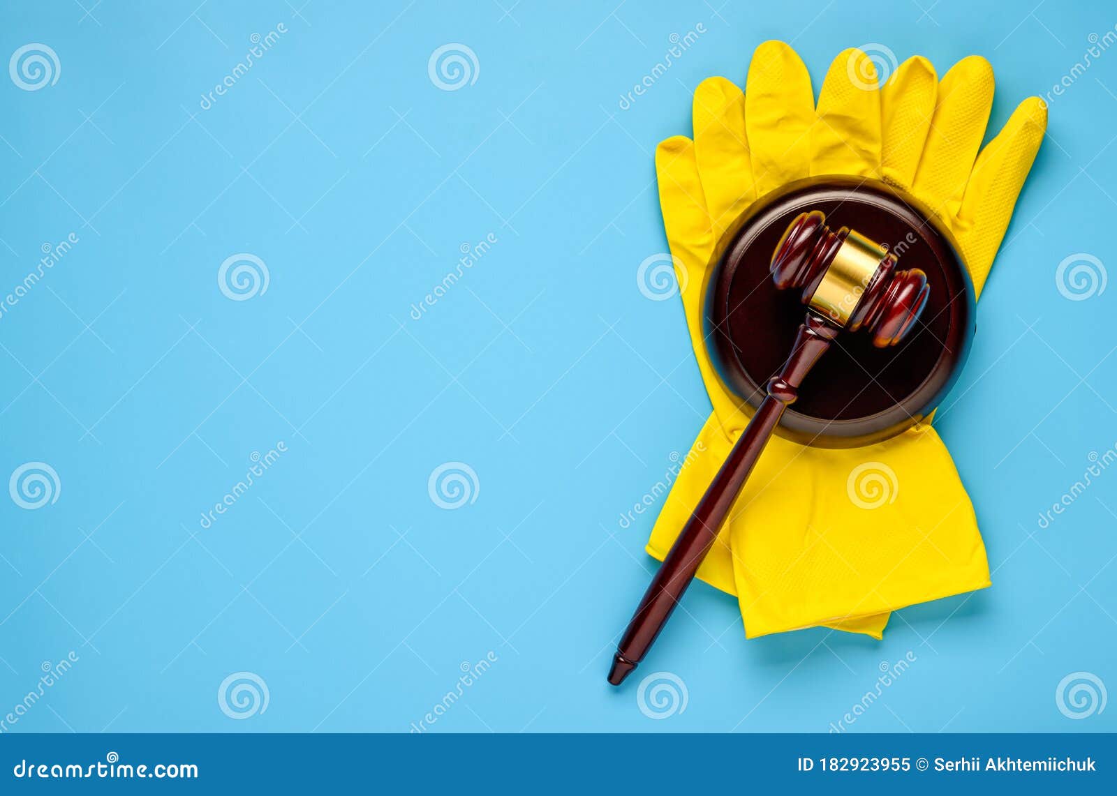 .rubber gloves and mallet on a blue background. concept of litigation at a cleaning company
