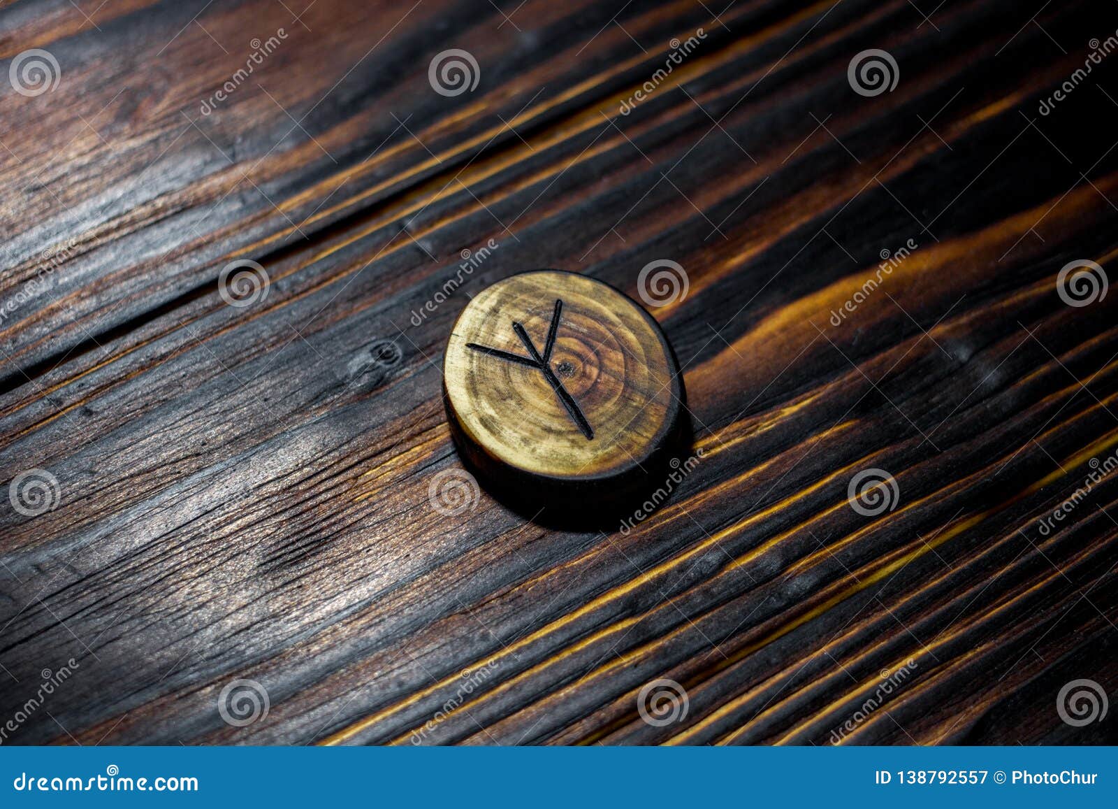 rune algiz elhaz carved from wood on a wooden background