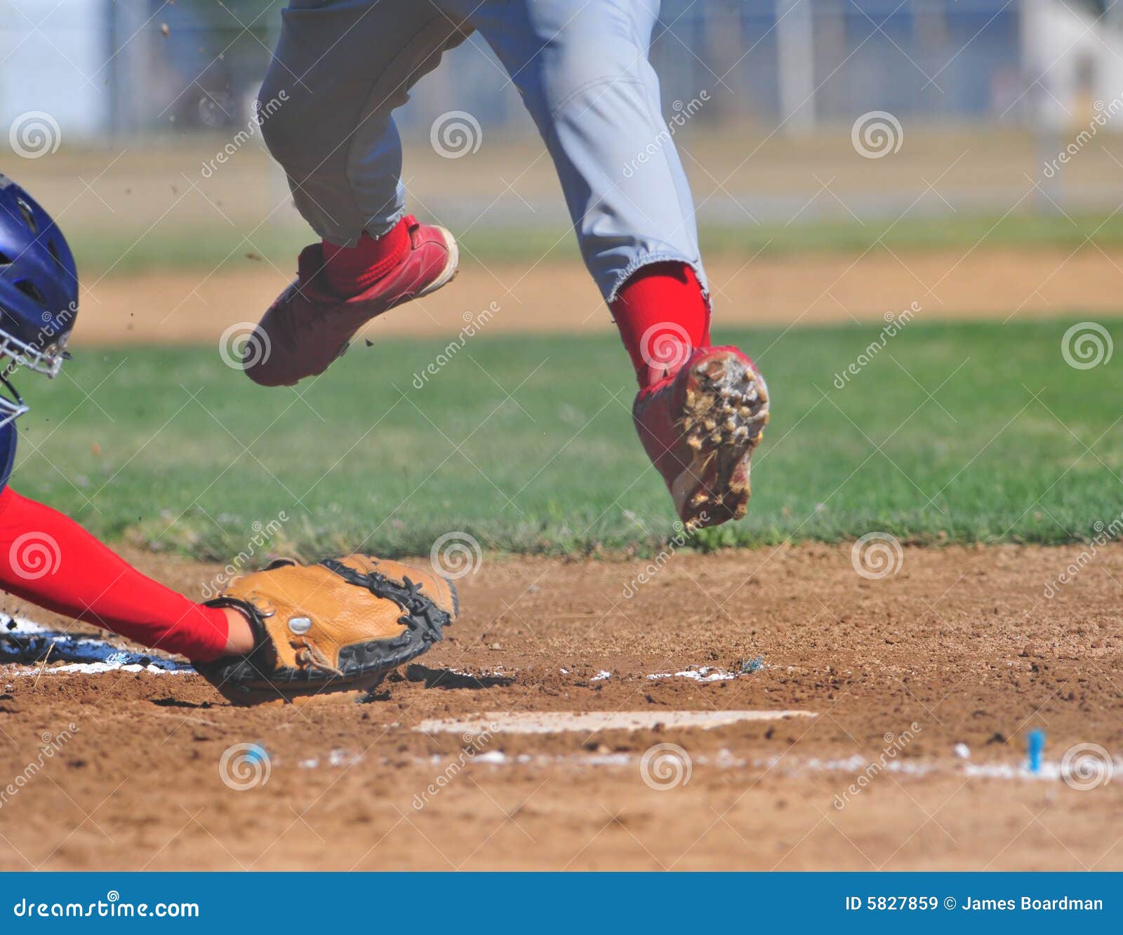 runner leaps over catchers mitt