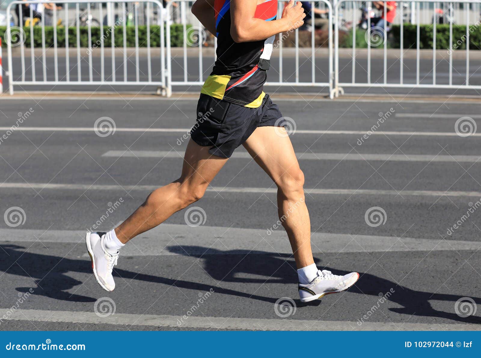 runner running on city road