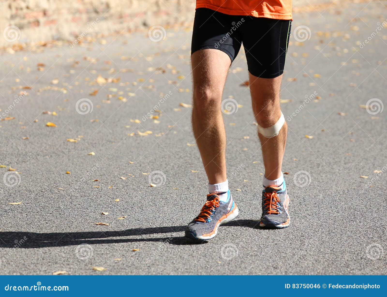 Runner Runs with a Patch Below the Knee Stock Photo Image of knee