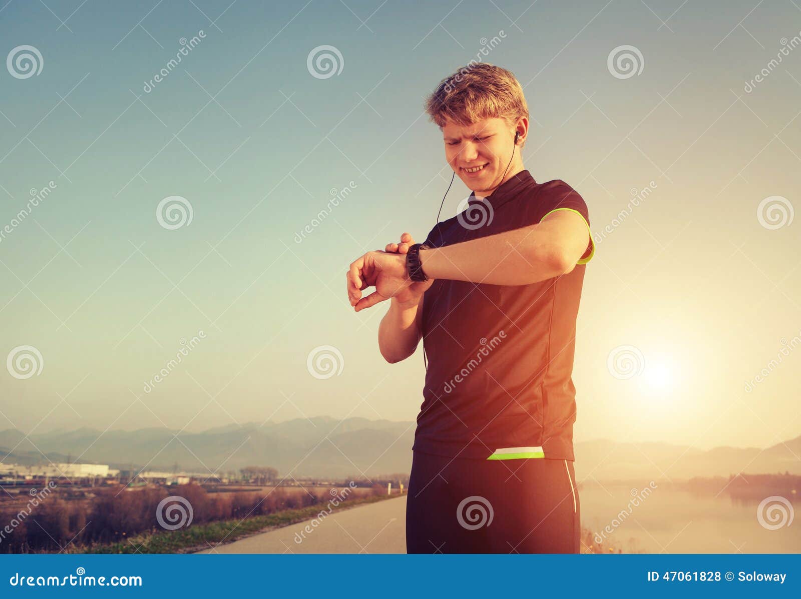 runner starts his modern stopwatch before jogging