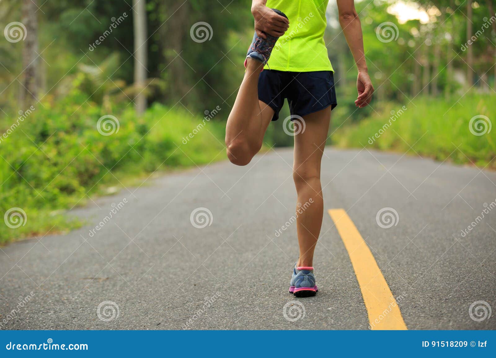 Runner Stretching Legs before Running at Morning Tropical Forest Trail ...