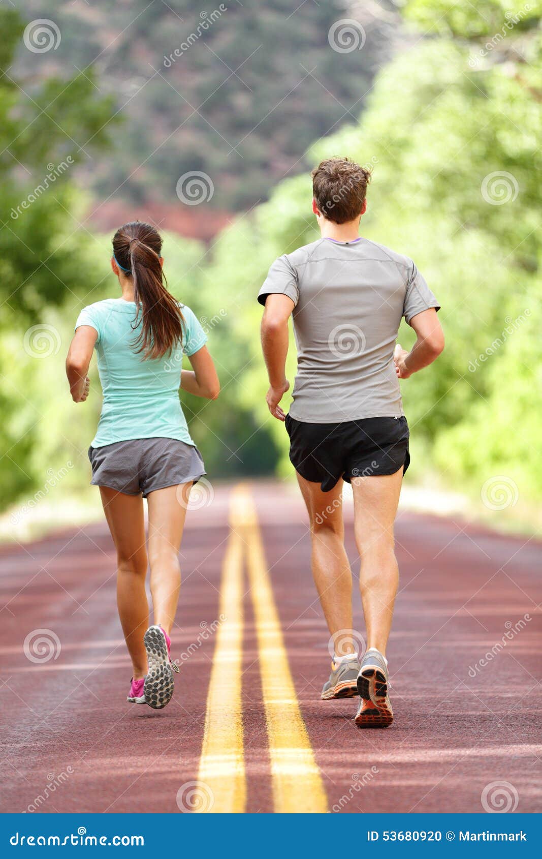 Portrait of confident female runner jogger training outdoors on bridge  alone, doing exercises, in sportive outfit, in the morning, cold day.  workout, sport, jogging, healthy lifestyle concept Stock Photo