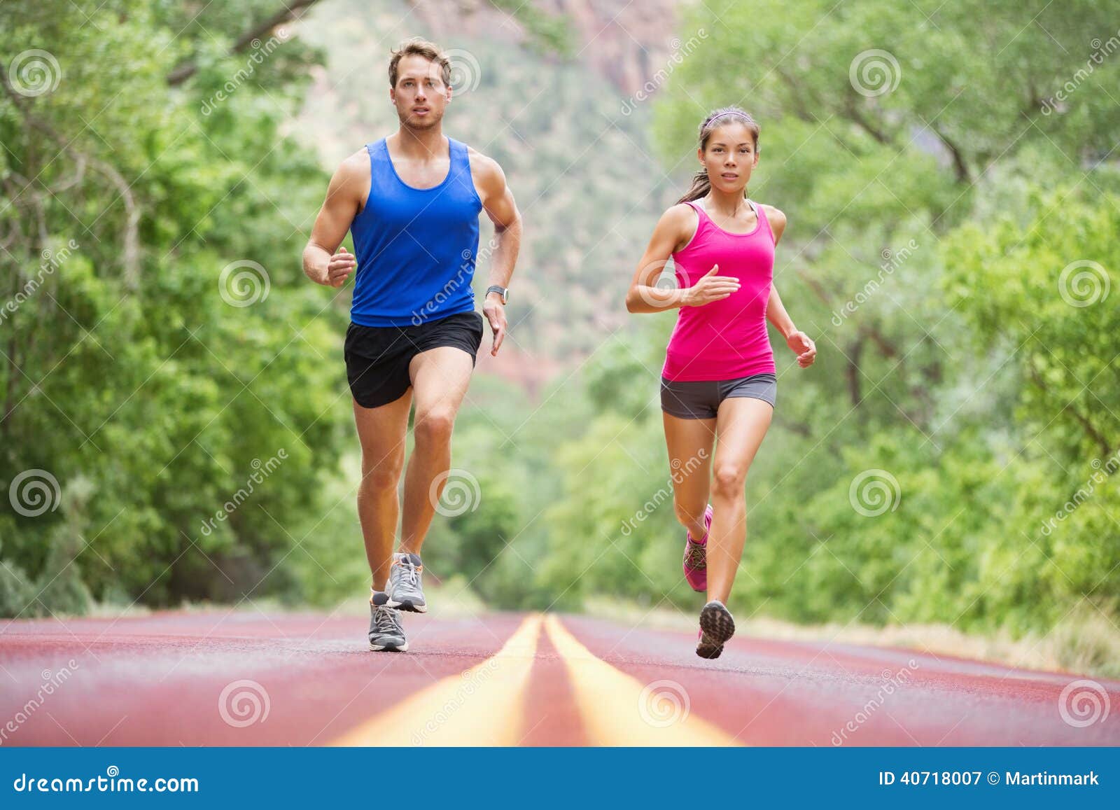 Sport Fitness Woman Running In Park On Summer Day. Asian Female Runner  During Outdoor Workout. Fit Sport Fitness Model Of Mixed Asian / Caucasian  Ethnicity. Stock Photo, Picture and Royalty Free Image.