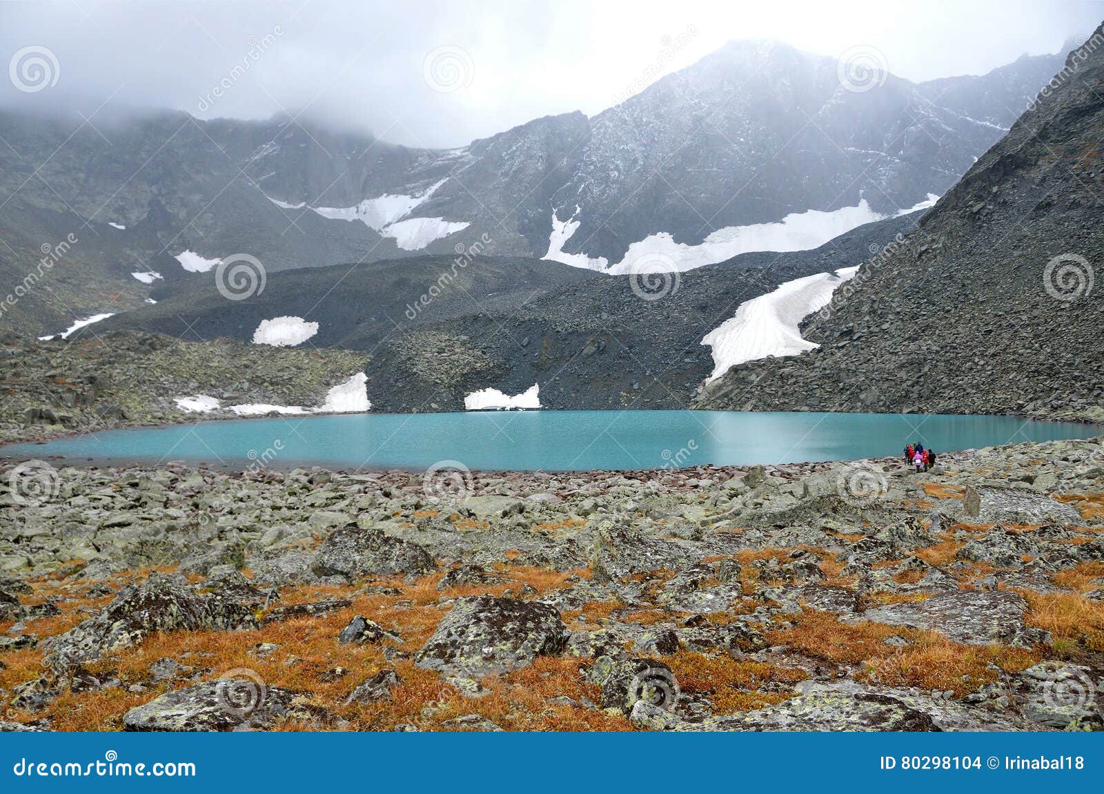 russia, the altai mountains, tourists walking near upper acchan akchan lake in overcast weather