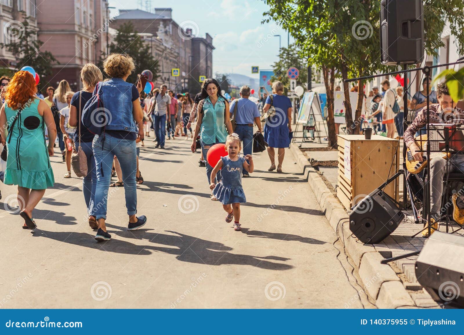 RUSSIA, Krasnoyarsk - August 25: a Little Girl with a Red Balloon Runs