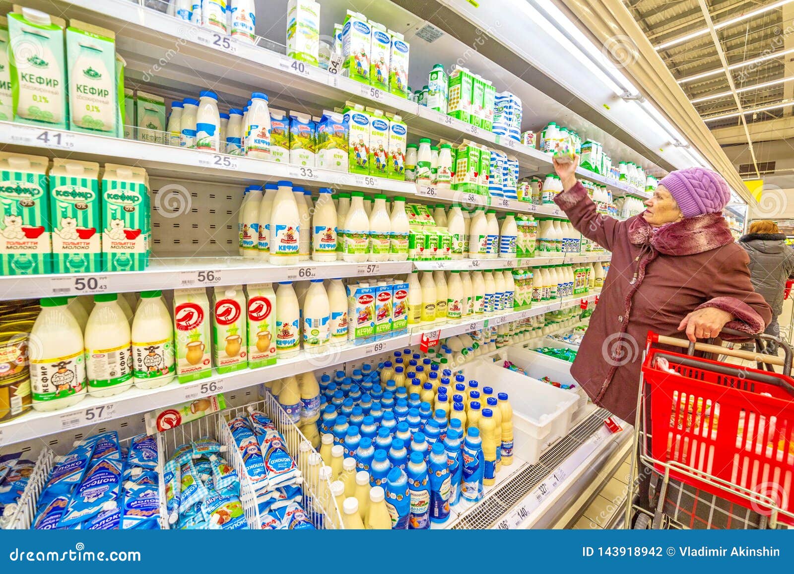 A Beautiful Mature Woman Chooses Dairy Products In The Supermarket Editorial Photography