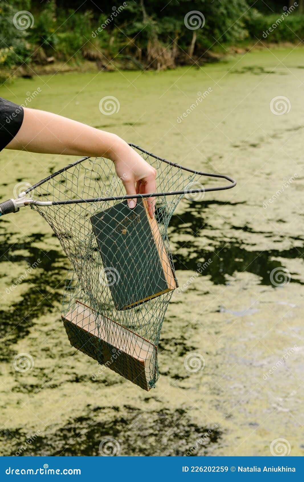 08/01/2021 Russia, Tula, Two Books are in a Fishing Net Over the Pond and a  Woman`s Hand Takes Out One of Them Stock Image - Image of reading, bloom:  226202259