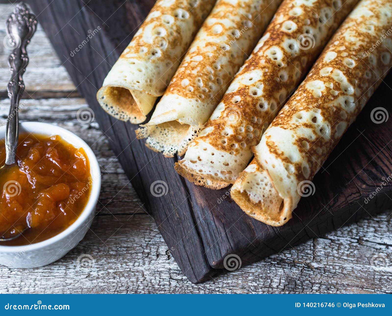 Russian Homemade Yeast Pancakes Rolled Into A Tube On Wood