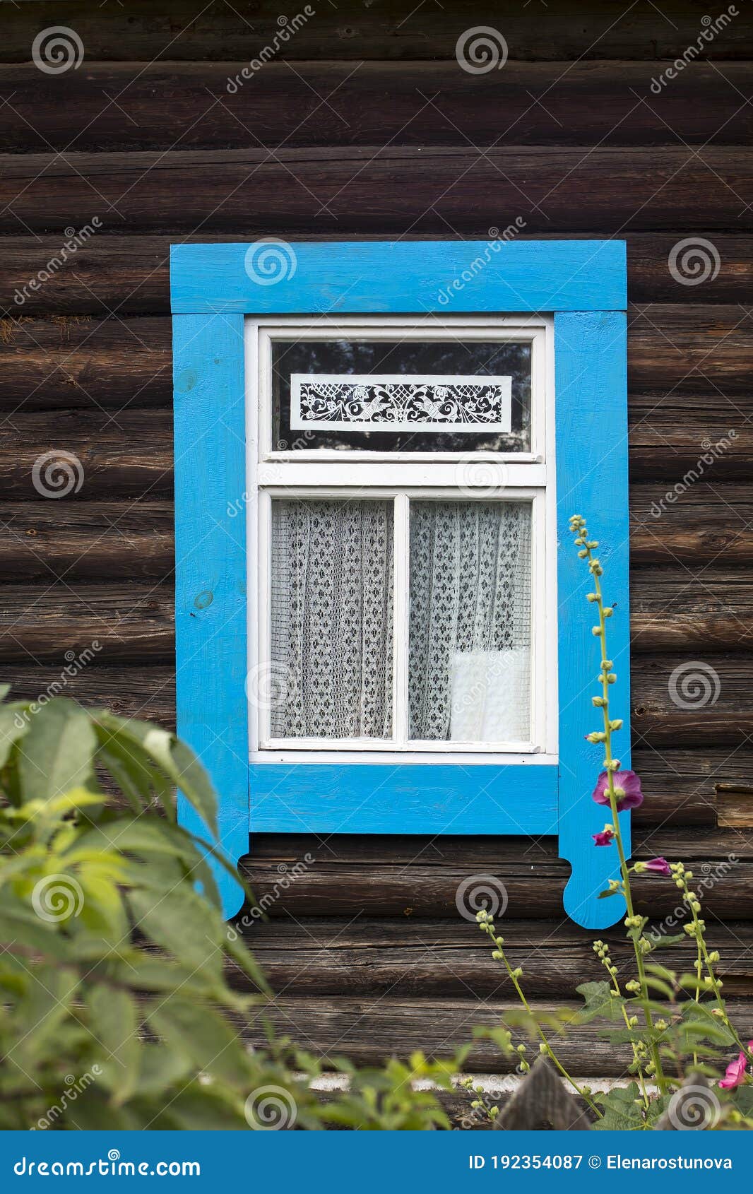 windows with carved frames and shutters in village houses