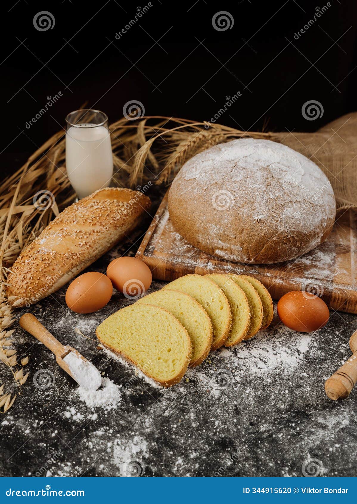 rustic bread, eggs, milk, and wheat on a dark surface for natural baking inspiration