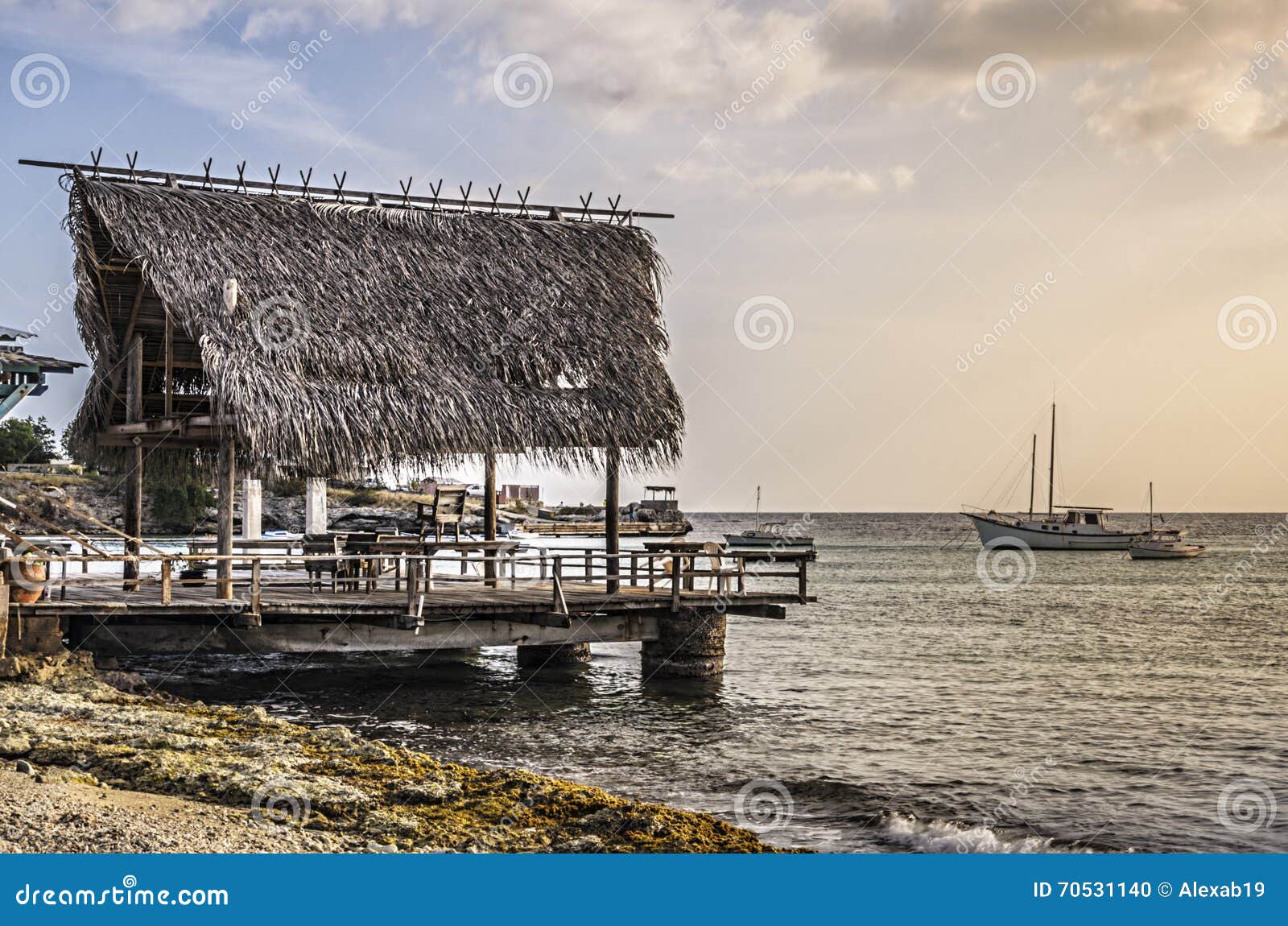 rustic fishing pier in curacao at sunset