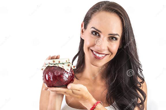 A Rustic Jar Full Of Tasty Jam Held By And Attractive Brunette 