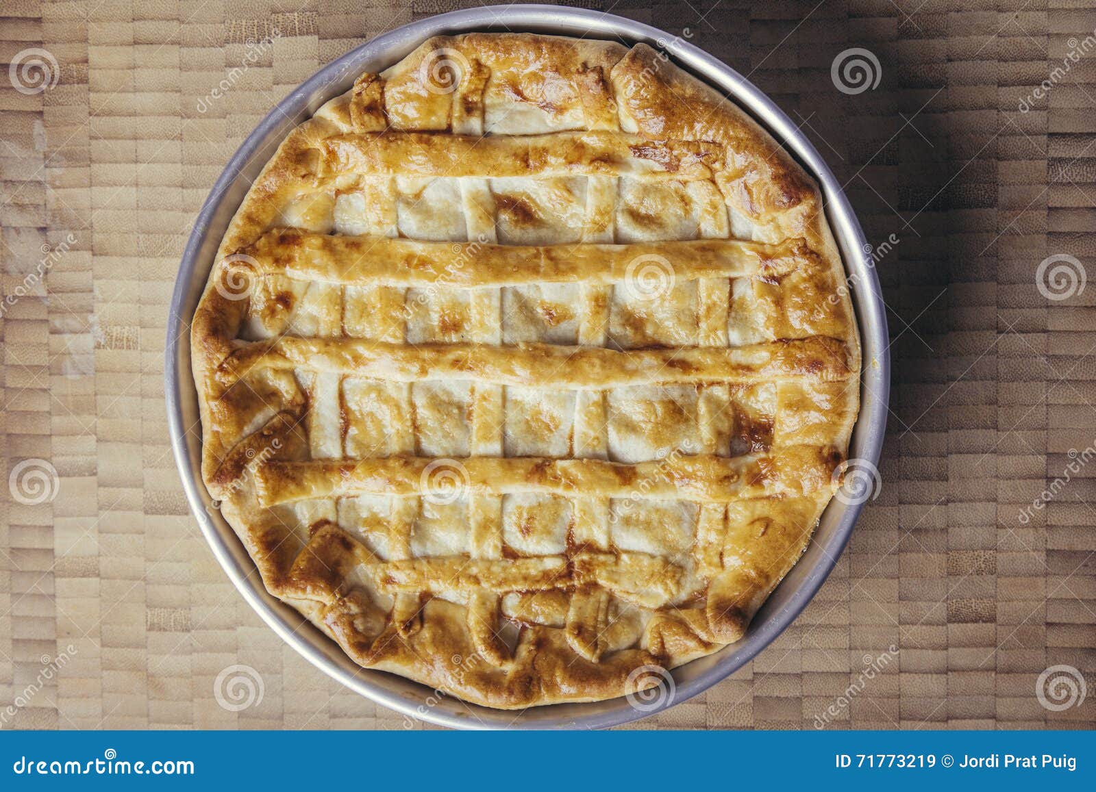 rustic meat striped pie on a wooden background