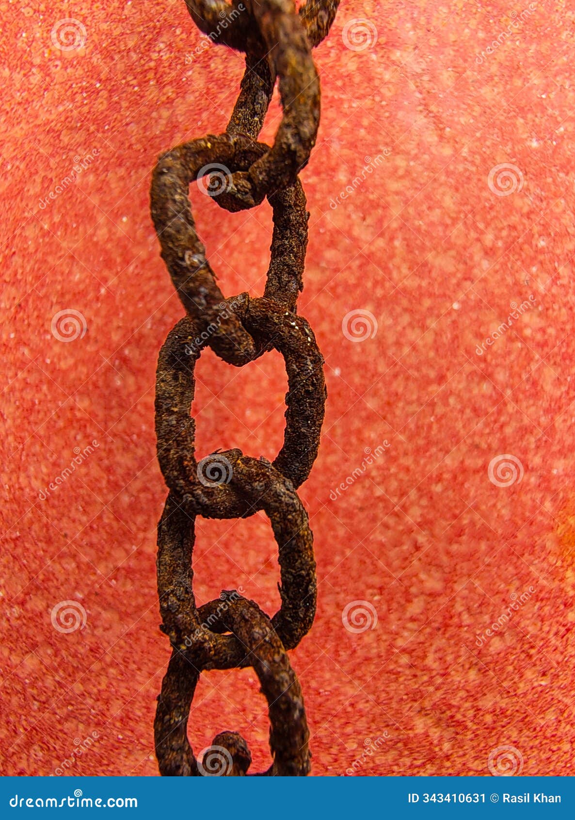 rustic metal chain on a red background selective focused vertical photo