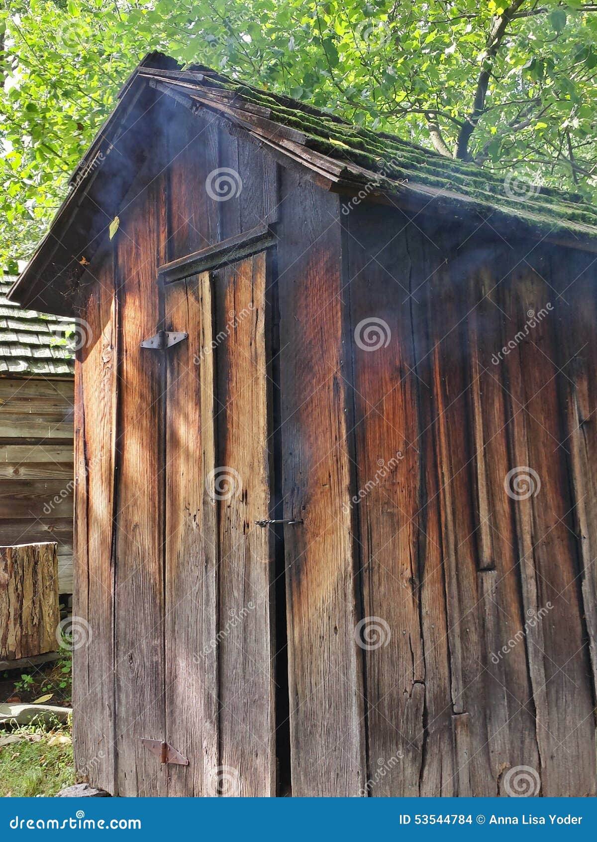 Rustic Old Meat Smokehouse With Smoke Leaking Out Stock 