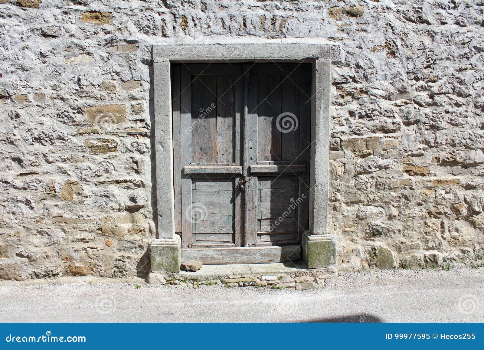 Rustic Wooden Doors on Stone Wall Stock Image - Image of wooden, boards ...