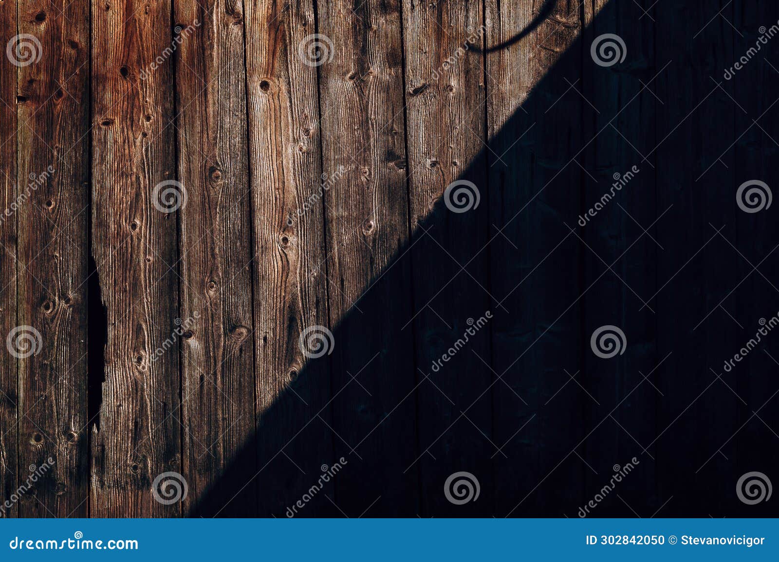 rustic wooden shed wall with diagonal shadow forming intricate pattern background and  