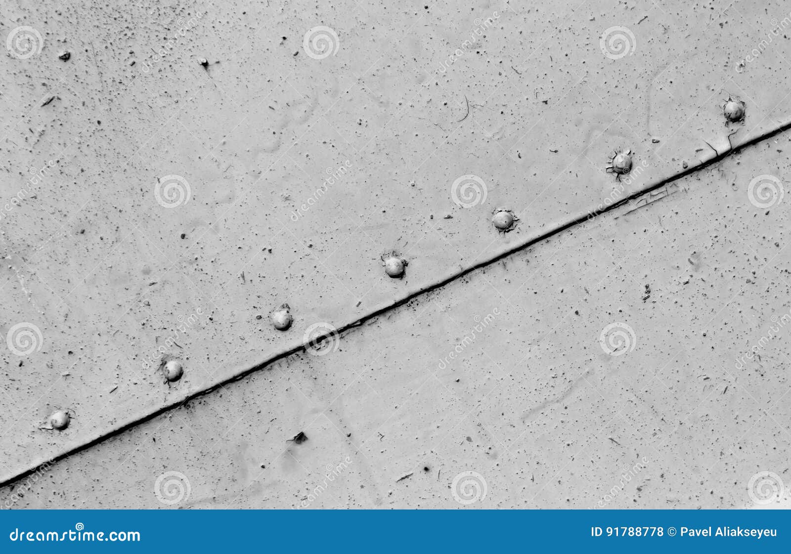 Rusty Black and White Metal Plate Surface with Rivets. Stock Photo