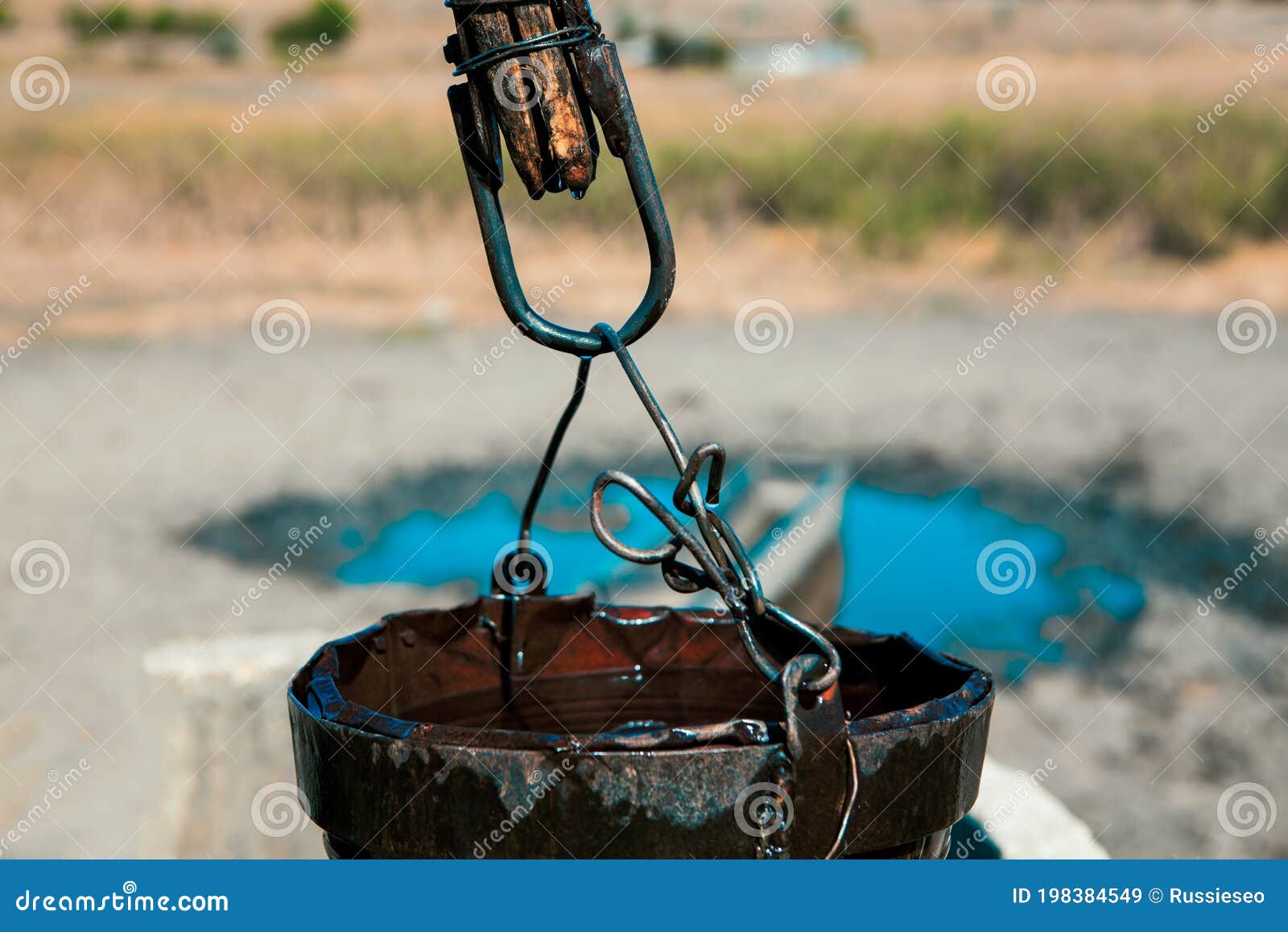 Rusty bucket of water well stock image. Image of drinking 198384549