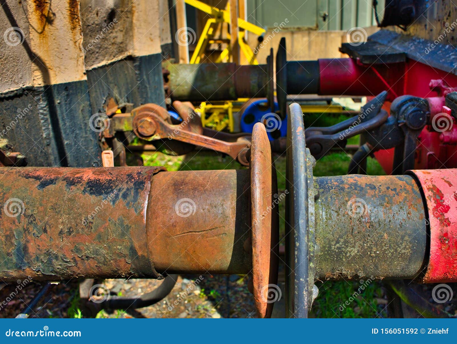 the rusty buffers of two old railway cars collide, transport