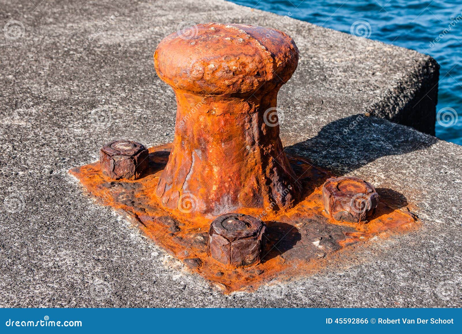 rusty old bollard on the dock of some harbour in pico-azores.