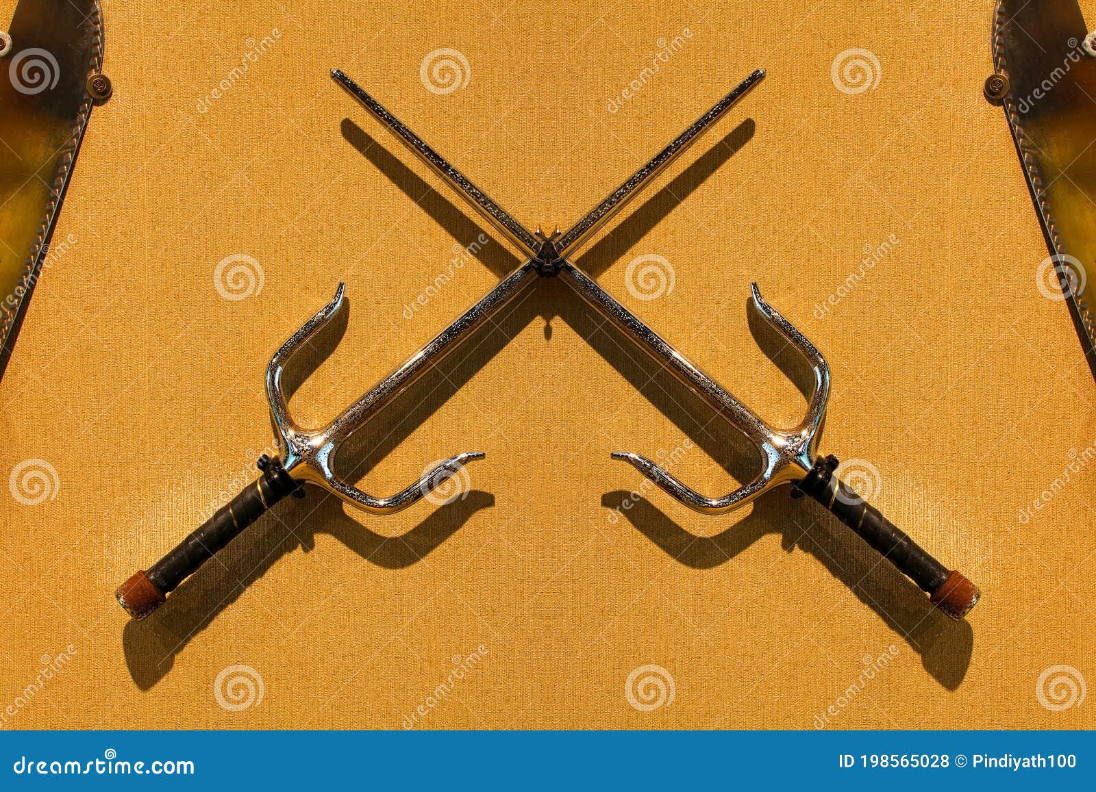 Rusty Pair of Octagonal Sai Martial Arts Weapon on Wall Stock Photo